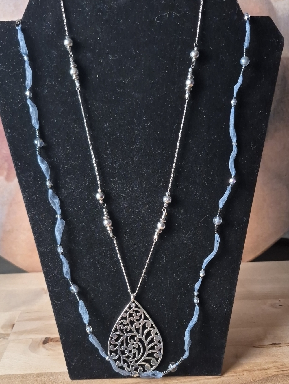 Silver Filigree Teardrop Necklace with Pale Blue Ribbon Accents